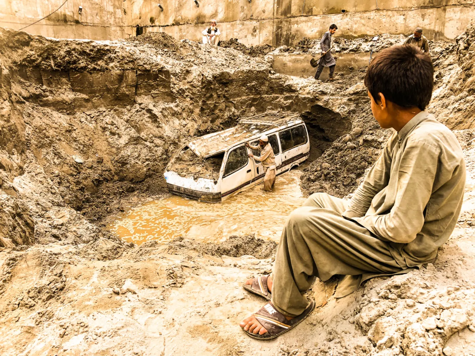 Vehicle stranded beside a landslide-damaged road