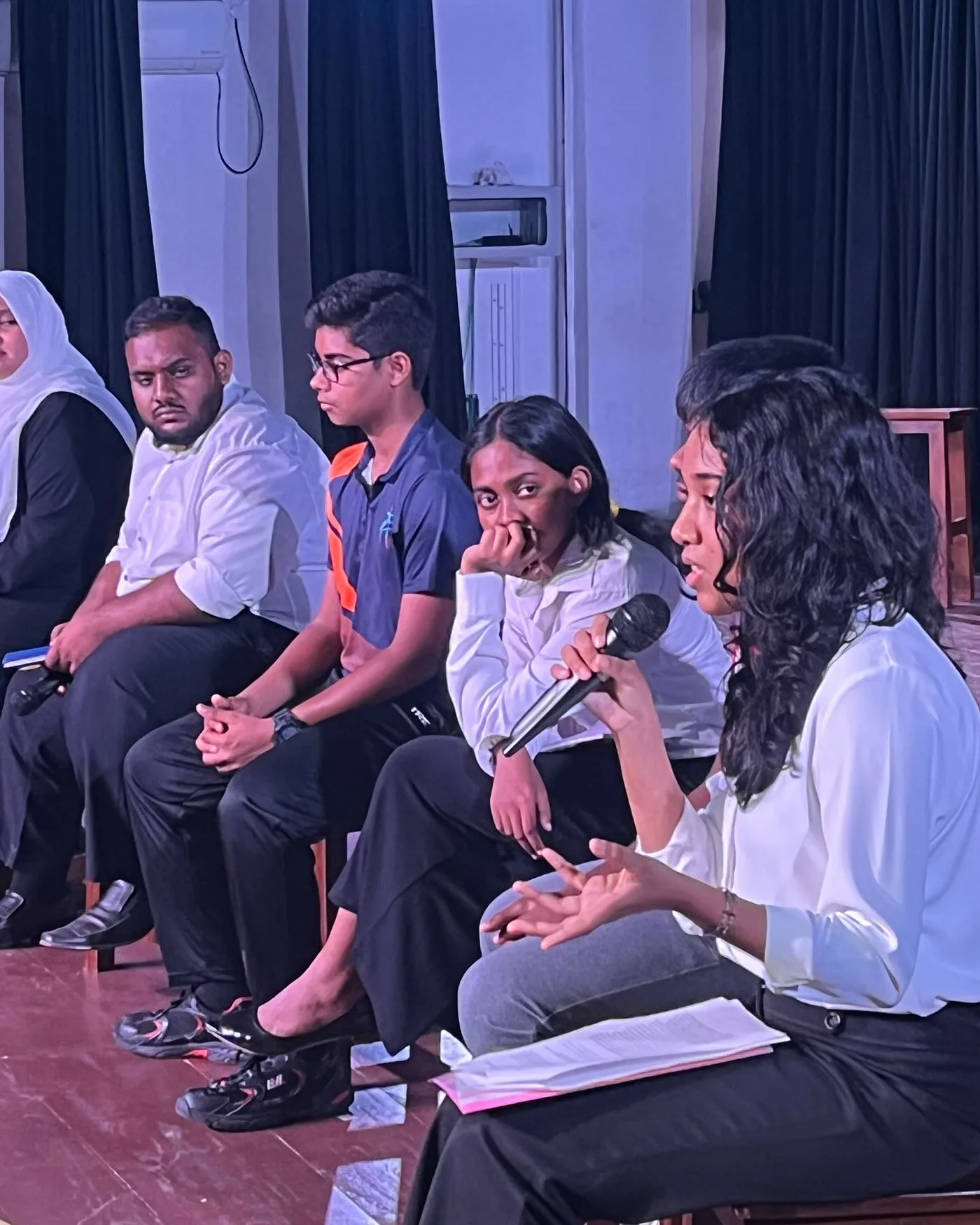 Young participants speaking during a panel discussion