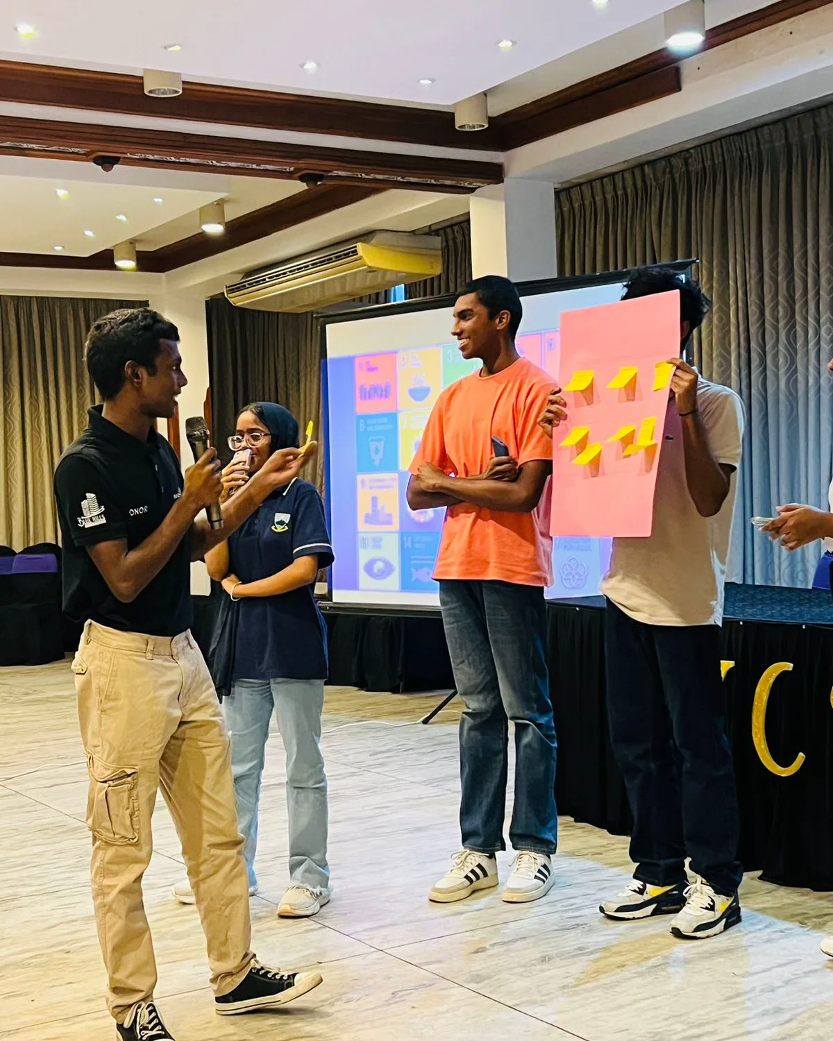 A student team explaining ideas from a group activity