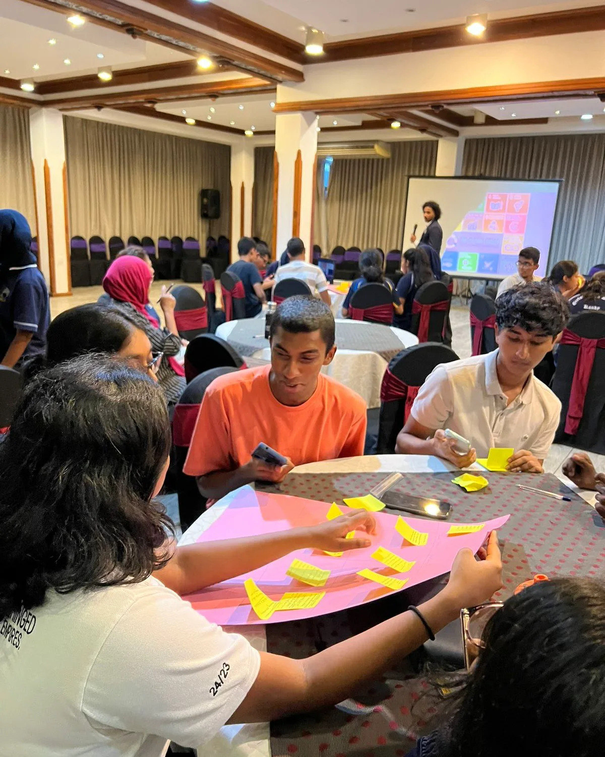 Students working together around a workshop table