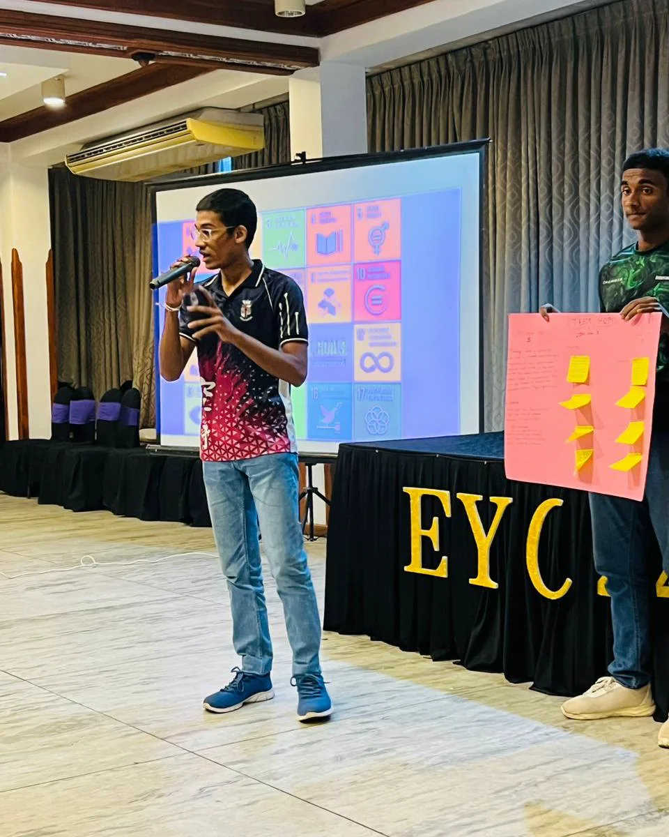 A young speaker presenting workshop findings